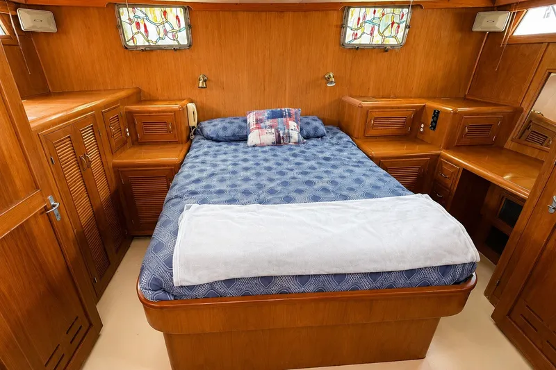 Slide: The Image of Luxurious cabin interior of 1988 Angel 45 AFT CABIN MV with wooden furnishings and cozy bedding. - 21