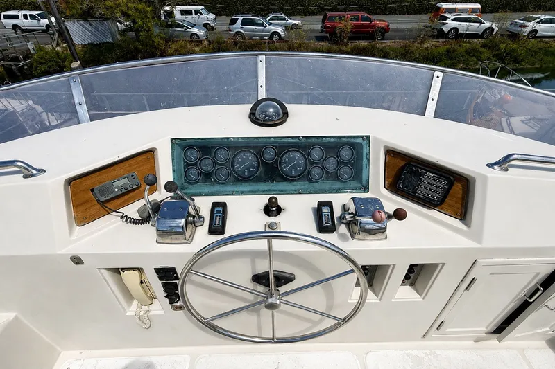 Slide: The Image of Control panel of a 1988 Angel 45 AFT CABIN MV boat with steering wheel and gauges. - 3
