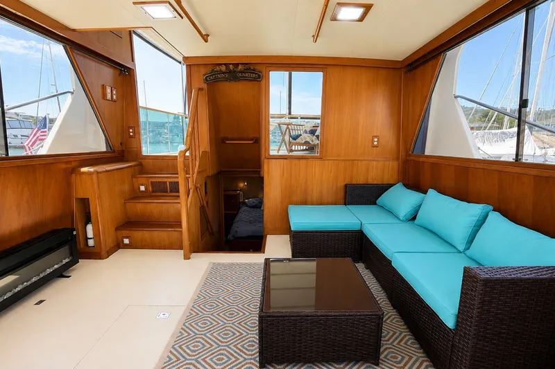 Slide: The Image of Luxurious 1988 Angel 45 AFT CABIN MV interior with turquoise seating and wooden accents. - 12