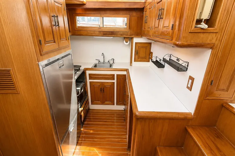 Slide: The Image of 1988 Angel 45 AFT CABIN MV kitchen with wooden cabinetry and stainless steel appliances. - 14