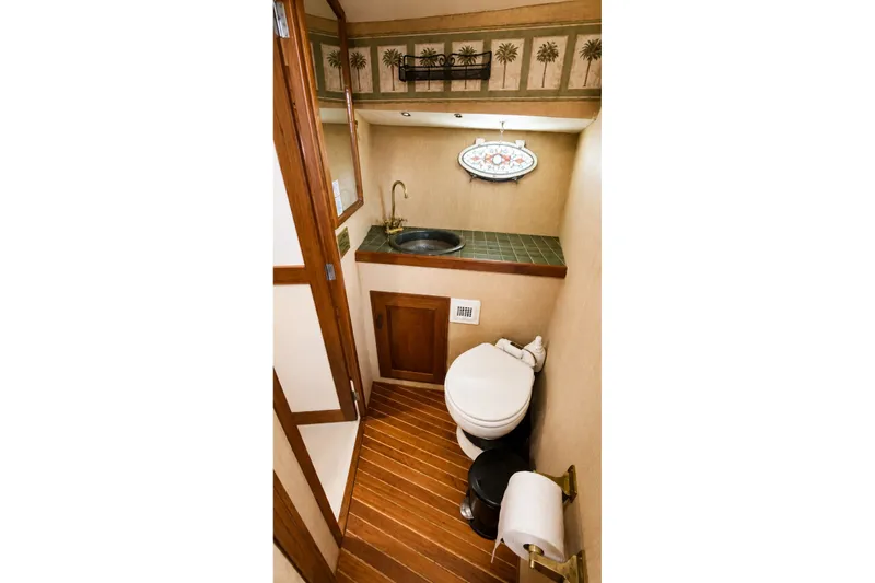 Slide: The Image of 1988 Angel 45 AFT CABIN MV bathroom with wood accents and compact design. - 25