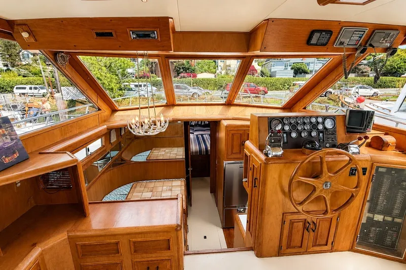 Slide: The Image of Interior of 1988 Angel 45 AFT CABIN MV yacht with wooden helm and panoramic windows. - 10