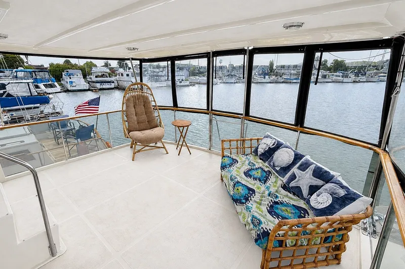 Slide: The Image of Aft cabin of 1988 Angel 45 yacht with cozy seating and marina view. - 8