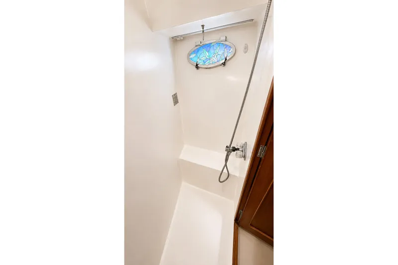 Slide: The Image of Shower area in 1988 Angel 45 AFT CABIN MV with stained glass window. - 23