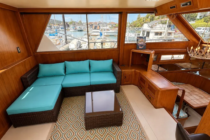 Slide: The Image of Luxurious interior of 1988 Angel 45 AFT CABIN MV yacht with turquoise seating and marina view. - 13