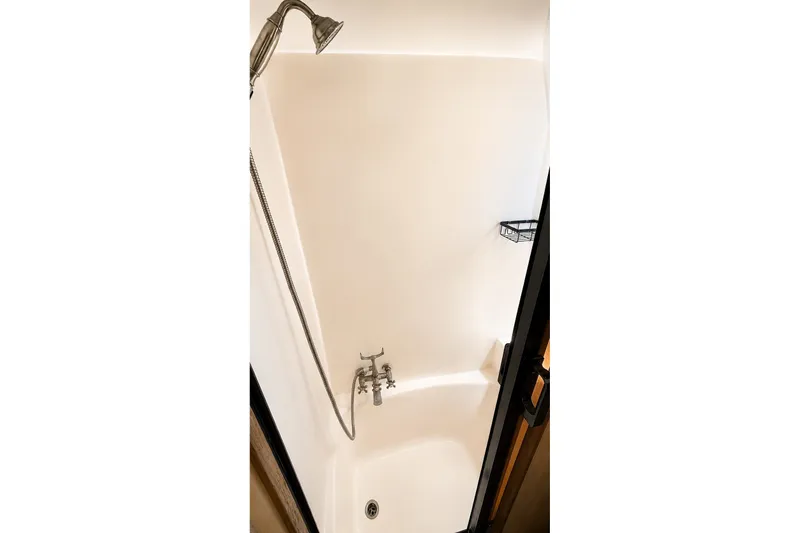 Slide: The Image of Shower area in 1988 Angel 45 AFT CABIN MV yacht, featuring a handheld showerhead. - 24