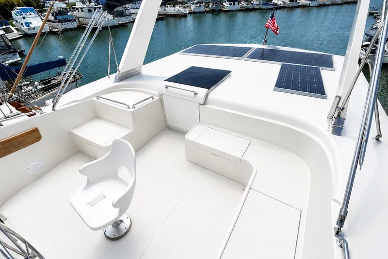 Slide: The Image of 1988 Angel AFT CABIN MY yacht deck with seating, solar panels, and marina view. - 4