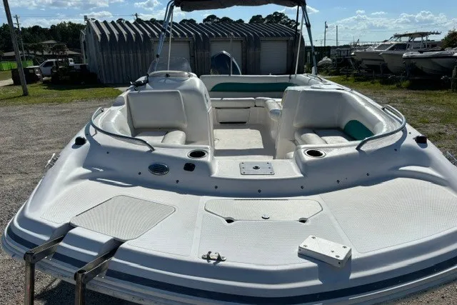 Slide: The Image of 2012 Hurricane SunDeck Sport 188 OB boat, white exterior, spacious seating, parked outdoors. - 4