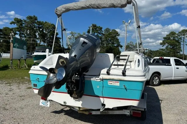 Slide: The Image of 2012 Hurricane SunDeck Sport 188 OB boat with outboard motor, parked on a trailer. - 3