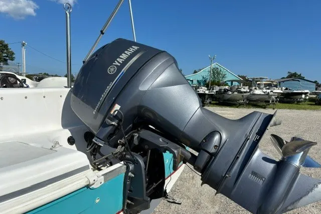 Slide: The Image of 2012 Hurricane SunDeck Sport 188 OB with Yamaha outboard motor in a boatyard setting. - 11