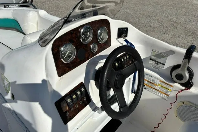 Slide: The Image of 2012 Hurricane SunDeck Sport 188 OB boat dashboard with steering wheel and control panel. - 8