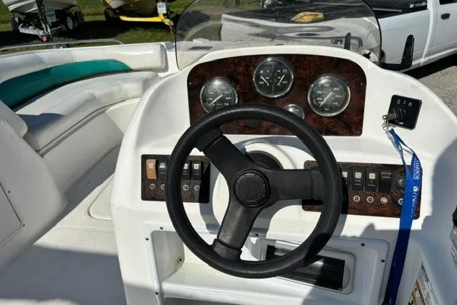 Slide: The Image of 2012 Hurricane SunDeck Sport 188 OB boat dashboard with steering wheel and gauges. - 9