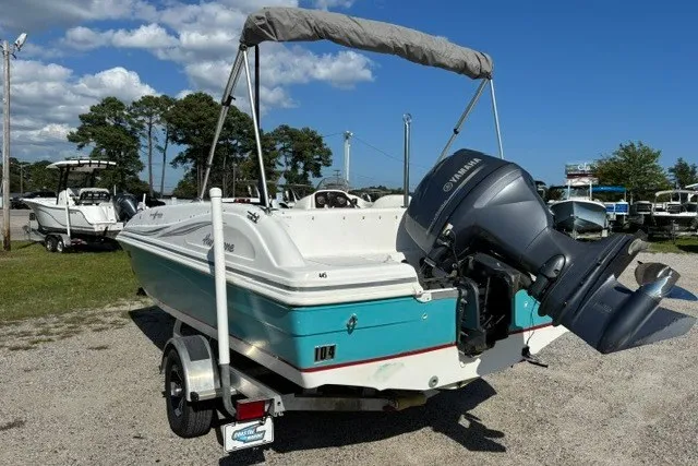 Slide: The Image of 2012 Hurricane SunDeck Sport 188 OB boat with Yamaha outboard motor on a trailer. - 2