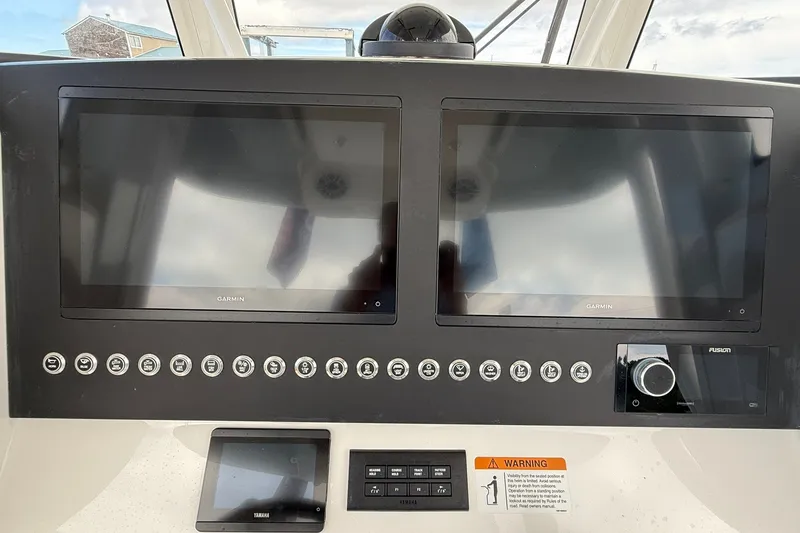 Slide: The Image of 2026 Regulator 28 boat dashboard with dual Garmin displays and control panel. - 22