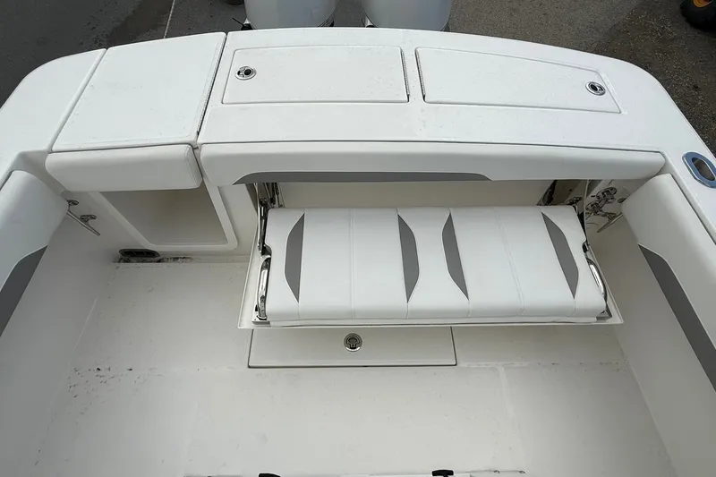 Slide: The Image of 2026 Regulator 28 boat with foldable rear seating and storage compartments. - 19