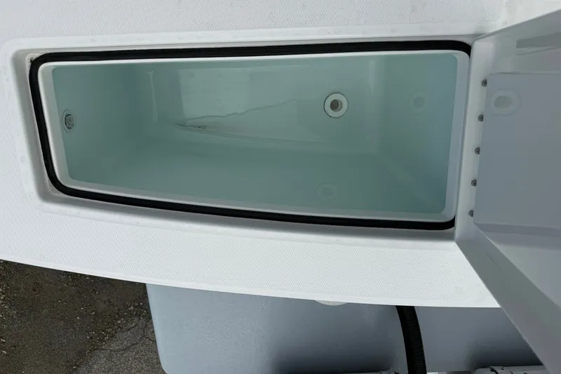 Slide: The Image of Open storage compartment on a 2026 Regulator 28 boat, showing interior details. - 25