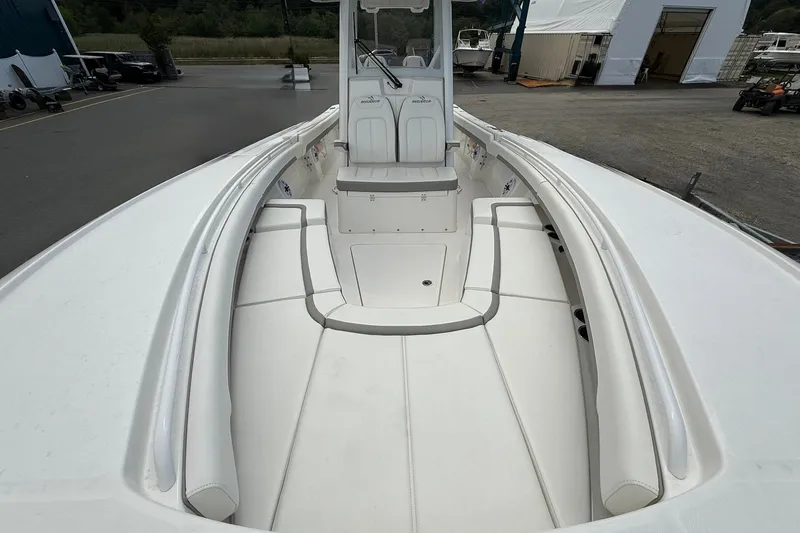 Slide: The Image of 2026 Regulator 28 boat interior with white seating and spacious deck. - 14
