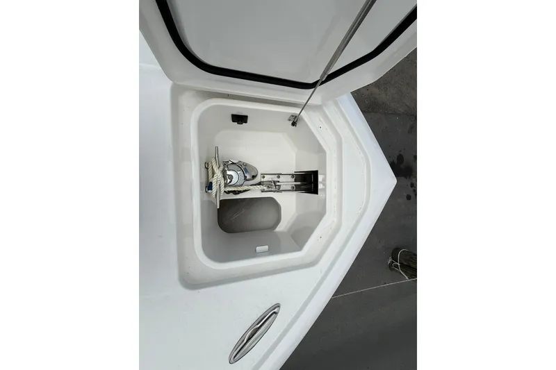 Slide: The Image of Anchor storage compartment on a 2026 Regulator 28 boat, featuring a neatly coiled rope. - 13