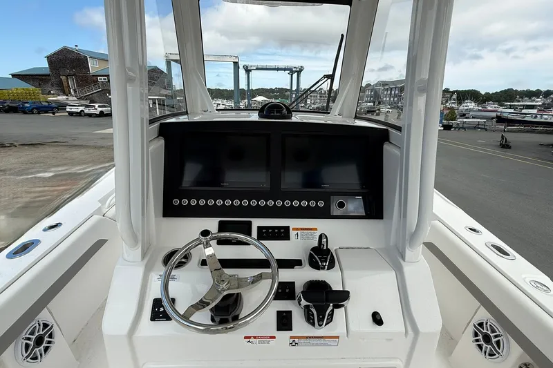 Slide: The Image of Helm of 2026 Regulator 28 boat with modern controls and dual screens. - 15