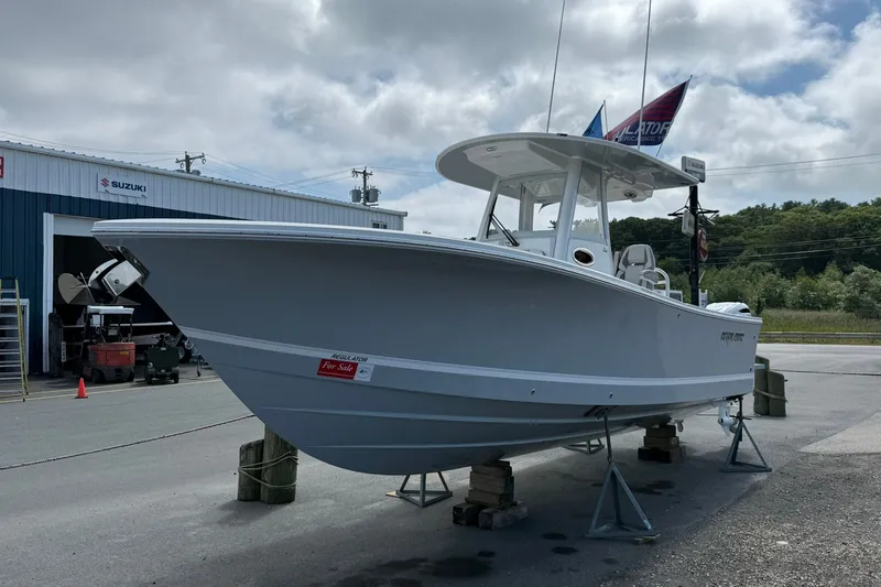 The Image of 2026 Regulator 28 boat for sale at a Suzuki dealership, displayed on stands. - 0