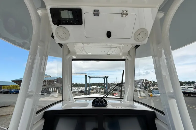 Slide: The Image of Interior view of 2026 Regulator 28 boat cockpit with marina background. - 20