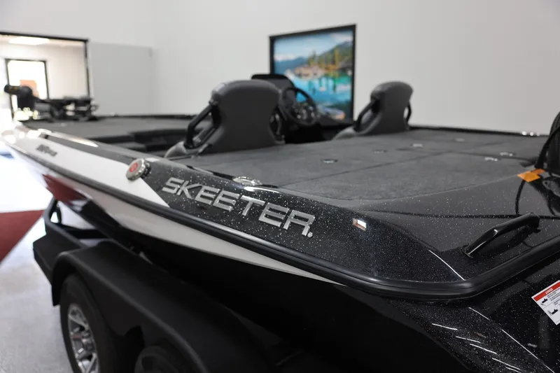 Slide: The Image of 2026 Skeeter ZXR19 SE boat in showroom, featuring sleek design and modern features. - 11