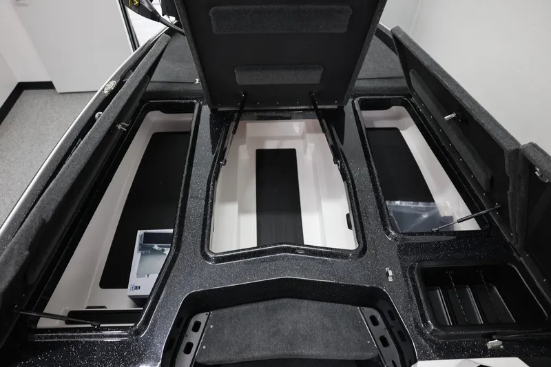 Slide: The Image of 2026 Skeeter ZXR19 SE boat storage compartments with open lids, showcasing interior space. - 8