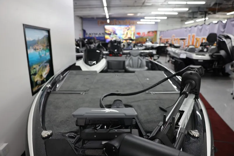 Slide: The Image of 2026 Skeeter ZXR19 SE boat displayed in a showroom with fishing equipment. - 3
