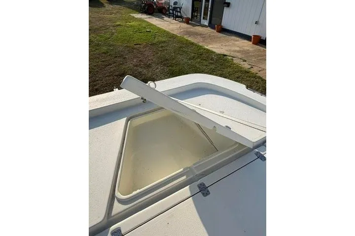 Slide: The Image of Open storage compartment on 2009 Twin Vee 22 BayCat boat deck. - 12