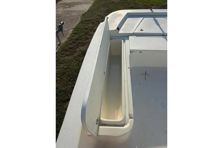 Slide: The Image of 2009 Twin Vee 22 BayCat boat interior with storage compartment and deck view. - 11