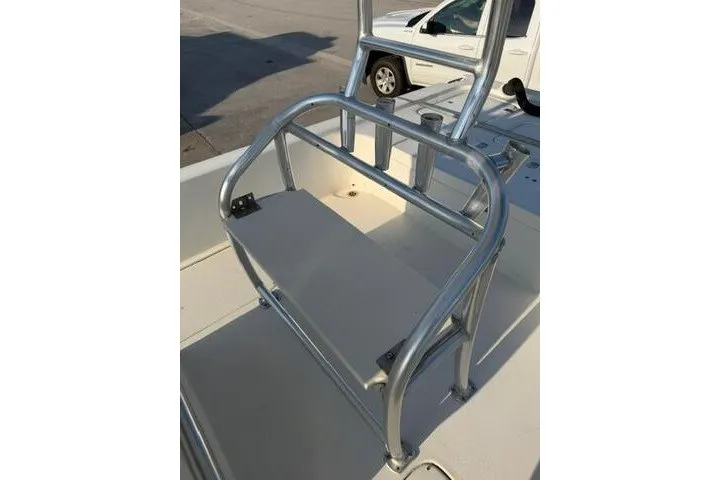 Slide: The Image of 2009 Twin Vee 22 BayCat boat with aluminum seating and railing, parked outdoors. - 21