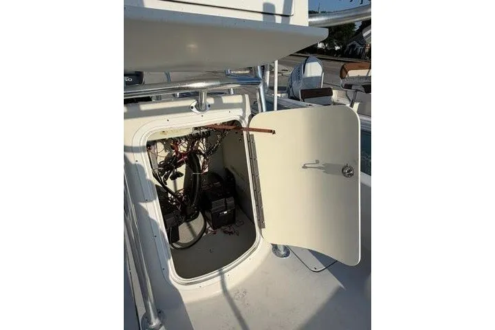 Slide: The Image of Open hatch on 2009 Twin Vee 22 BayCat boat showing internal wiring and components. - 15