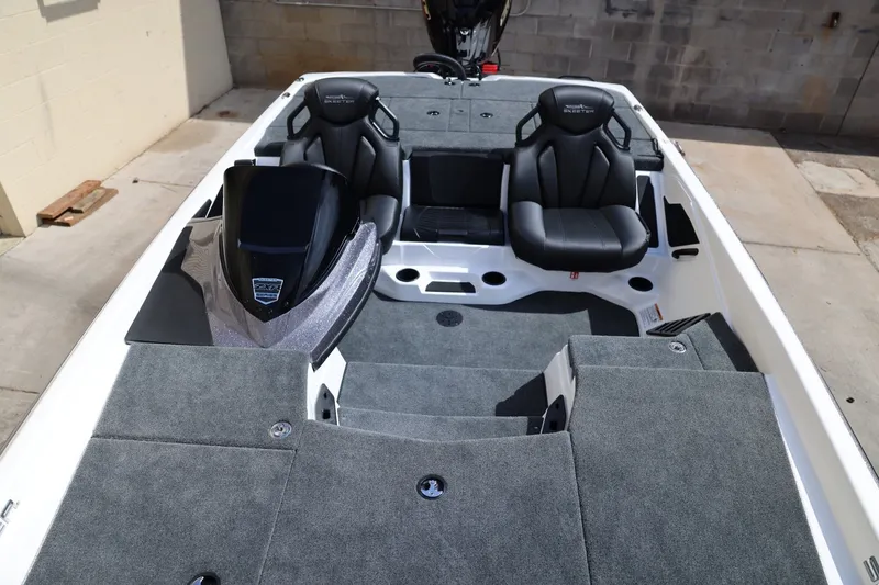 Slide: The Image of 2026 Skeeter ZXR20 SE boat interior with gray carpet and black seats. - 13