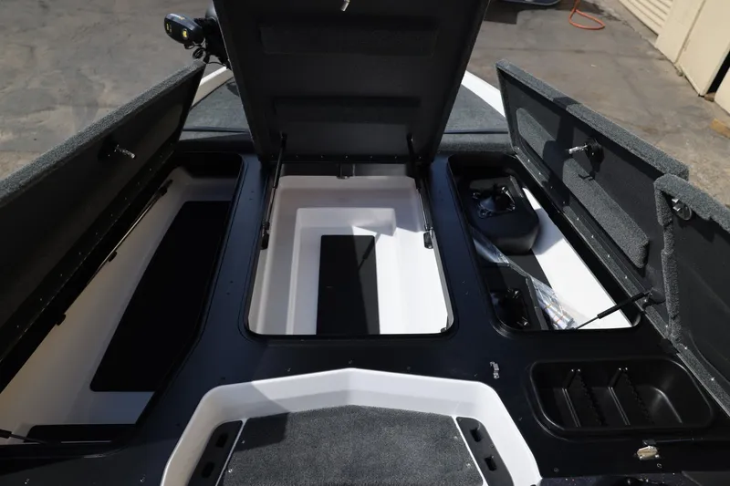 Slide: The Image of 2026 Skeeter ZXR20 SE boat storage compartments open, showcasing spacious interior design. - 15
