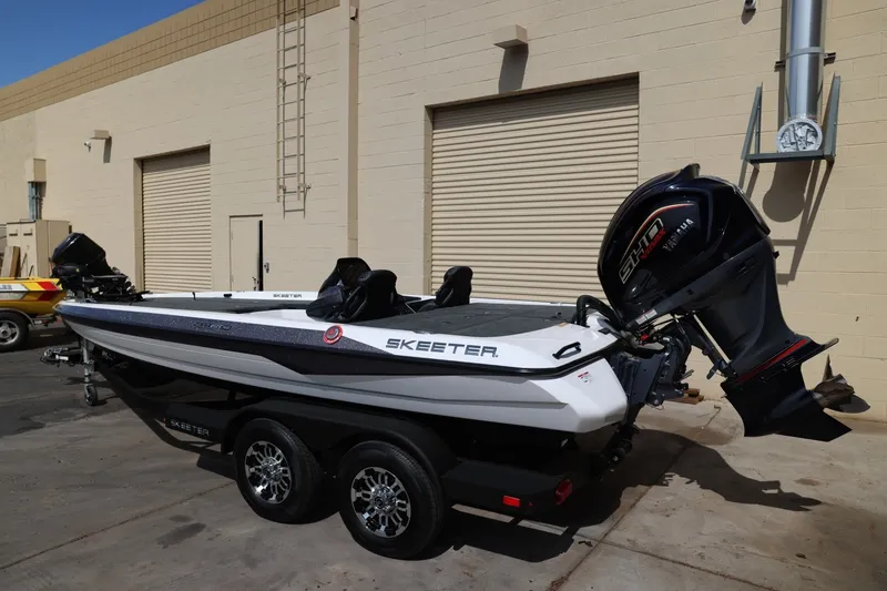 Slide: The Image of 2026 Skeeter ZXR20 SE boat with powerful outboard motor, parked outdoors. - 5