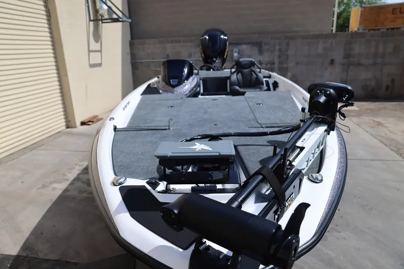 Slide: The Image of 2026 Skeeter ZXR20 SE boat with advanced fishing equipment, parked outdoors. - 10
