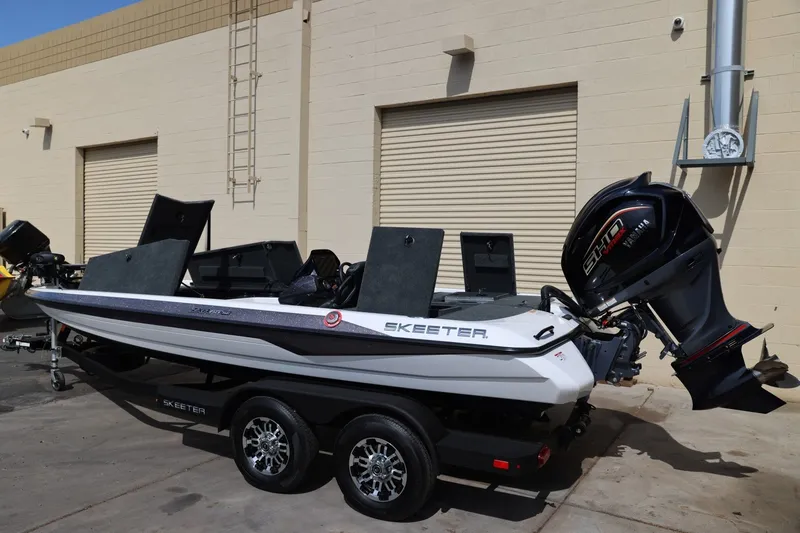 Slide: The Image of 2026 Skeeter ZXR20 SE boat with Yamaha engine on trailer, parked outside a building. - 17