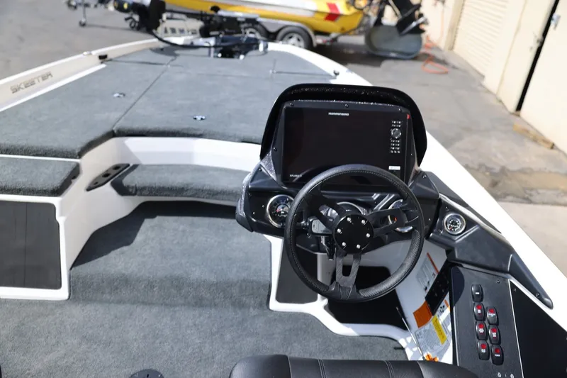 Slide: The Image of 2026 Skeeter ZXR20 SE boat cockpit with steering wheel and control panel. - 12