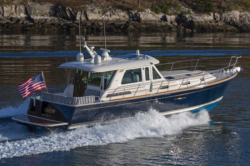 Slide: The Image of Manufacturer Provided Image: 2022 Sabre 48 Salon Express cruising on water with American flag. - 60