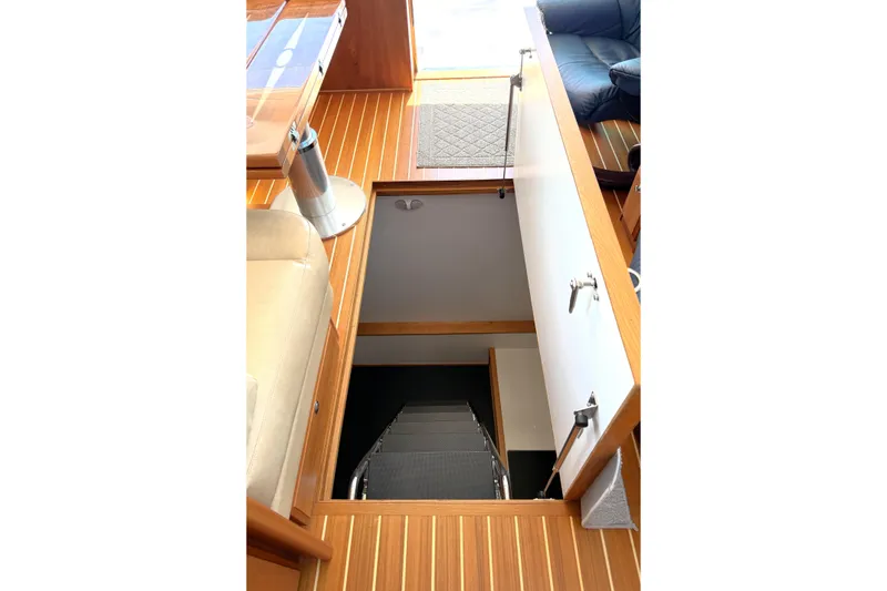 Slide: The Image of Interior view of 2022 Sabre 48 Salon Express yacht with open hatch and wooden flooring. - 39