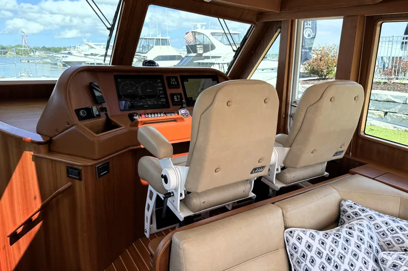 Slide: The Image of Interior of 2022 Sabre 48 Salon Express yacht with helm and seating area. - 3