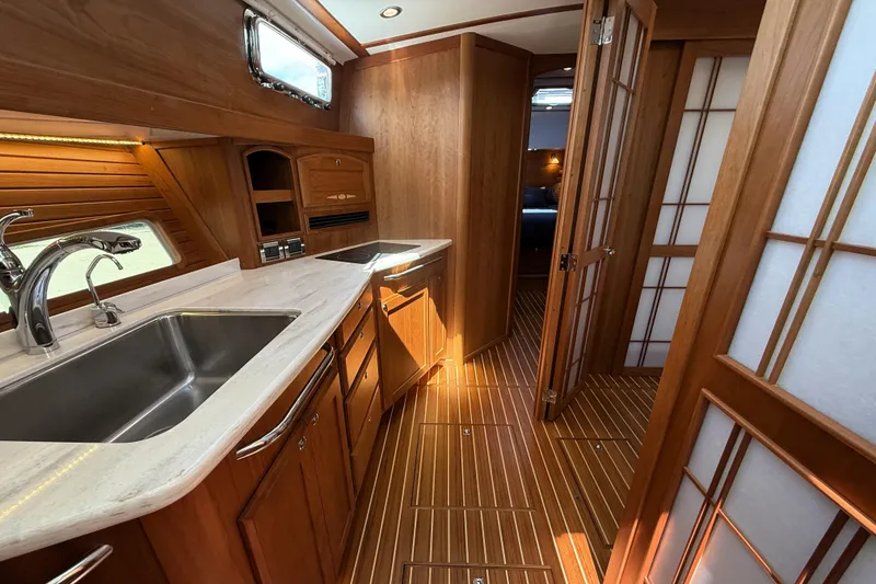 Slide: The Image of Luxurious 2022 Sabre 48 Salon Express yacht interior with elegant wood finishes and modern kitchen. - 32