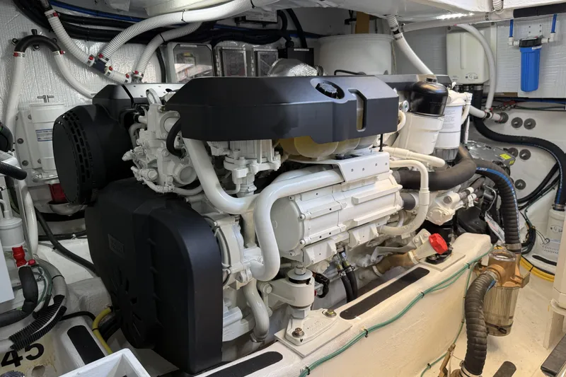 Slide: The Image of Engine room of 2022 Sabre 48 Salon Express yacht, showcasing advanced machinery and components. - 56