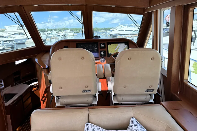 Slide: The Image of Interior of 2022 Sabre 48 Salon Express yacht, featuring helm station and luxurious seating. - 22