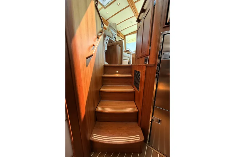 Slide: The Image of Interior wooden staircase of 2022 Sabre 48 Salon Express yacht, leading to upper deck. - 38