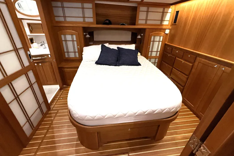 Slide: The Image of Luxurious bedroom interior of 2022 Sabre 48 Salon Express yacht with wooden finishes. - 4