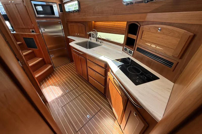 Slide: The Image of Luxurious kitchen interior of 2022 Sabre 48 Salon Express yacht with wood finish. - 30