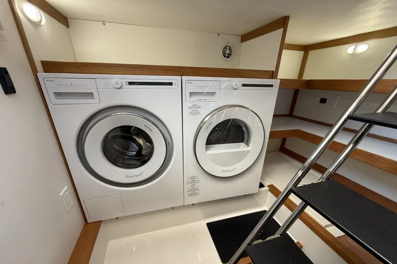 Slide: The Image of Laundry area with washer and dryer inside 2022 Sabre 48 Salon Express yacht. - 42