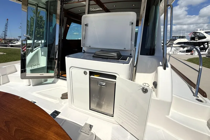 Slide: The Image of Outdoor kitchen area on 2022 Sabre 48 Salon Express yacht, featuring grill and storage. - 9