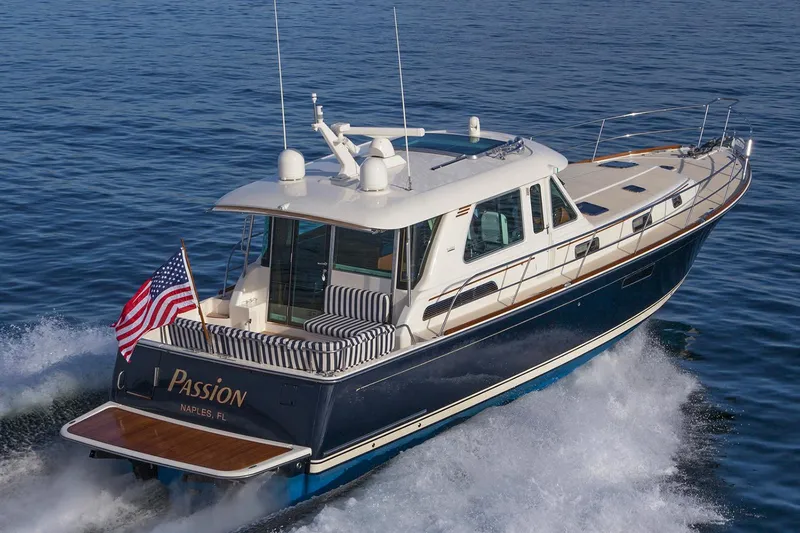 Slide: The Image of Manufacturer Provided Image: 2022 Sabre 48 Salon Express yacht cruising on the water with American flag. - 59